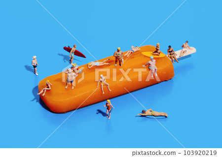miniature people in swimsuit on an orange popsicle miniature people in swimsuit on an orange popsicle 103920219