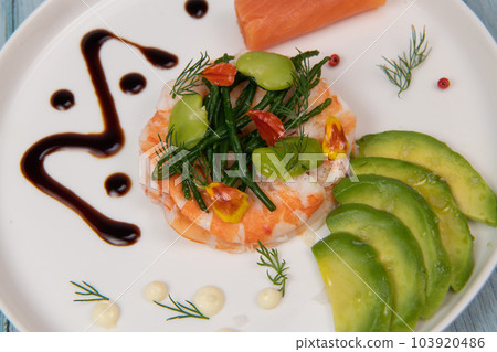 Fish Appetizer shrimp carpaccio, smoked salmon, avocado, samphire in white round plate 103920486