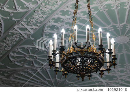 Luxury vintage chandelier with candle lights, classic interior Luxury vintage chandelier with candle lights, classic interior 103921048