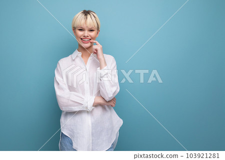 young successful blond career woman in a white shirt on a blue background with copy space. career 103921281