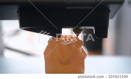 3D printer. 3d printer printing close-up. Molten plastic flowing out of extruder and forming prototype model. New modern additive technologies for printing 3D printer. Electronic device for modeling. 103921500