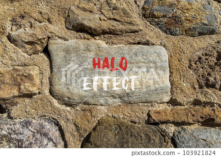 Halo effect and psychological symbol. Concept words Halo effect on beautiful big grey stone. Beautiful stone wall background. Business psychological and Halo effect concept. Copy space. 103921824