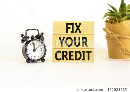 Fix your credit symbol. Concept words Fix your credit on wooden blocks on a beautiful white table white background. Black alarm clock. Business, finacial and fix your credit concept. Copy space. Fix your credit symbol. Concept words Fix your credit on wooden blocks on a beautiful white table white background. Black alarm clock. Business, finacial and fix your credit concept. Copy space. 103921885