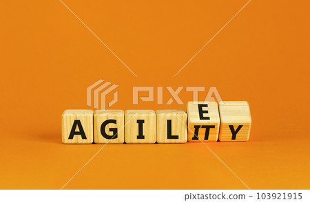 Agile and agility symbol. Concept words Agile and Agility on wooden cubes. Beautiful orange table orange background. Business agile and agility concept. Copy space. 103921915