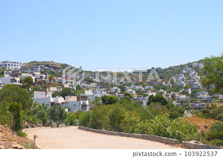 View of the highway, houses and mountains on the Aegean coast of Turkey, orange groves. May 2023. View of the highway, houses and mountains on the Aegean coast of Turkey, orange groves. May 2023. 103922537