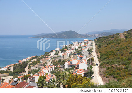 View of the highway, houses and mountains on the Aegean coast of Turkey, orange groves. May 2023. View of the highway, houses and mountains on the Aegean coast of Turkey, orange groves. May 2023. 103922571
