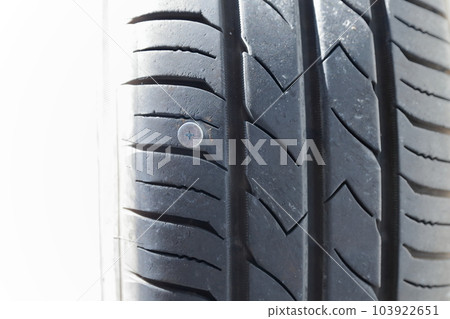 car tire punctured with nails car tire punctured with nails 103922651