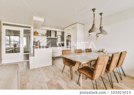 a kitchen and dining area in a house with wood flooring, white walls, wooden floors and large windows a kitchen and dining area in a house with wood flooring, white walls, wooden floors and large windows 103923013