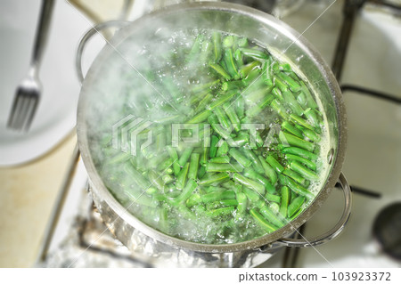 Pan of green beans ready for cooking, top view. Green bush beans boiling in hot water. 103923372