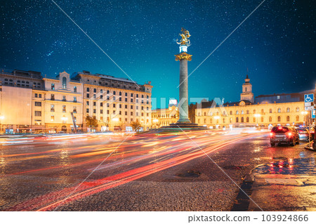 Tbilisi, Georgia, Eurasia. Amazing Bold Bright Blue Starry Sky Gradient Above Liberty Monument Depicting St George Slaying The Dragon And Tbilisi City Hall In Freedom Square In City Center. Travel Tbilisi, Georgia, Eurasia. Amazing Bold Bright Blue Starry Sky Gradient Above Liberty Monument Depicting St George Slaying The Dragon And Tbilisi City Hall In Freedom Square In City Center. Travel 103924866