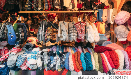 Crafted Knitted Traditional European Warm Clothes - Mittens At Winter Christmas Market. Souvenir From Europe. Hand Crafted Warm Clothes In Christmas Store. Various Multicolored Mittens And Gloves Crafted Knitted Traditional European Warm Clothes - Mittens At Winter Christmas Market. Souvenir From Europe. Hand Crafted Warm Clothes In Christmas Store. Various Multicolored Mittens And Gloves 103924874