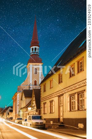 Parnu, Estonia. Night View Of Kuninga Street With Old Houses In Evening Night Illuminations. Bold Bright Blue Starry Sky. View Of Lutheran Church Of St. Elizabeth On Background. Travel To Estonia 103924919