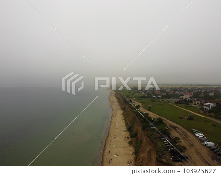 Scenic coastal view of tall cliffs covered with vegetation on a sunny spring day Scenic coastal view of tall cliffs covered with vegetation on a sunny spring day 103925627