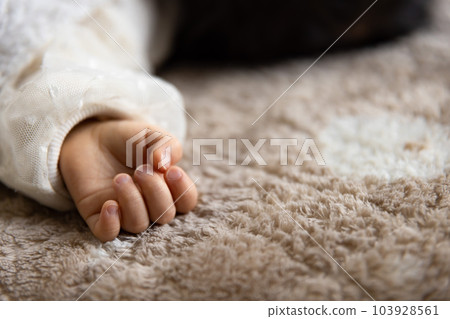 The right hand of an infant taking a nap in the living room The right hand of an infant taking a nap in the living room 103928561