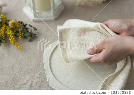 Woman's hand setting the table Woman's hand setting the table 103930528