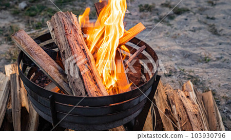 bonfire bonfire stand flame campfire evening sunset coast sunset outside copy space 103930796