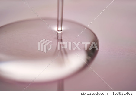 A juicy drop of gel on a purple background. A juicy drop of gel on a purple background. 103931462