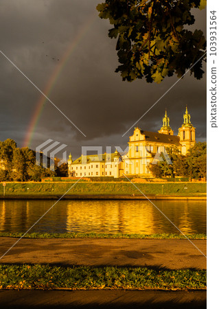 Heavy rain and rainbow above the Vistula river in Krakow Poland. Stunning views of the city rainy season and rainbow 103931564
