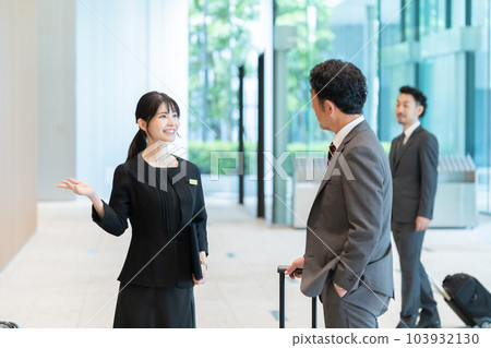Hotel staff guiding guests 103932130