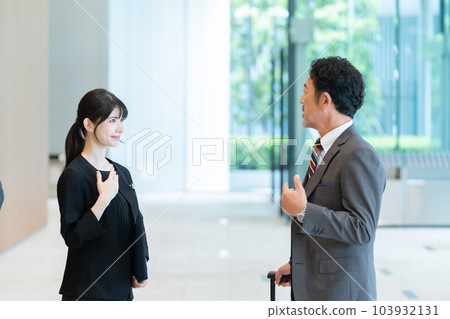 Hotel staff guiding guests 103932131