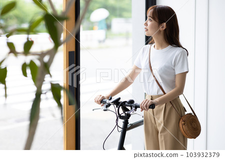 woman going out by bicycle 103932379
