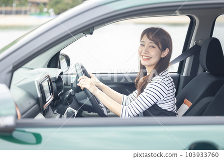 A woman driving a car A woman driving a car 103933760