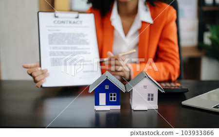 Signing a contract. Client and broker agent, lease agreement, successful deal and Young business sitting at the desk Signing a contract. Client and broker agent, lease agreement, successful deal and Young business sitting at the desk 103933866