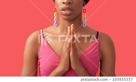 Prayer gesture. Faith hope. Forgiveness blessing. Unrecognizable disturbed desperate woman namaste folded hands isolated on pink free space. Prayer gesture. Faith hope. Forgiveness blessing. Unrecognizable disturbed desperate woman namaste folded hands isolated on pink free space. 103935357