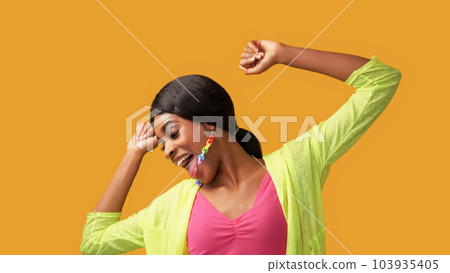Happy dance. Fun joy. Positive lifestyle. Excited amused carefree smiling woman enjoying freedom luck isolated on bright orange color empty space background. 103935405