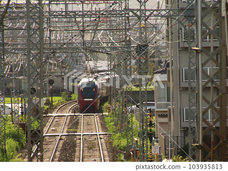 Kintetsu's Meihan Limited Express "Hinotori" passing through the jungle of overhead wire pillars Kintetsu's Meihan Limited Express "Hinotori" passing through the jungle of overhead wire pillars 103935813