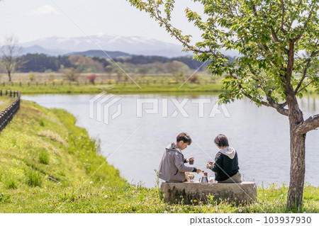 A couple taking a coffee break, waterfront, vintage style A couple taking a coffee break, waterfront, vintage style 103937930
