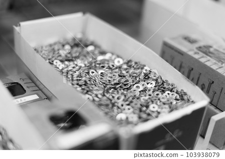 Small thin metal nails, hardware, screw lying in a store container. 103938079