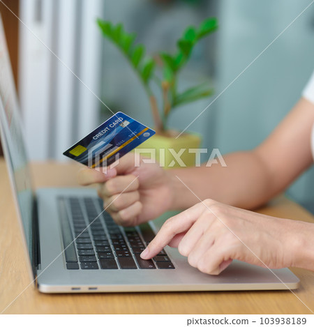 woman hand holding credit card and using laptop for online shopping while making order at home. Marketplace platform website, technology, ecommerce, digital banking and online payment concept woman hand holding credit card and using laptop for online shopping while making order at home. Marketplace platform website, technology, ecommerce, digital banking and online payment concept 103938189
