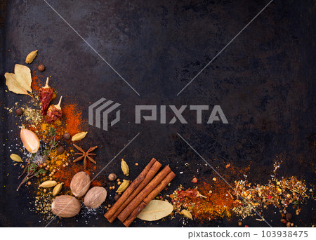 Different spices and herbs on a black background Different spices and herbs on a black background 103938475