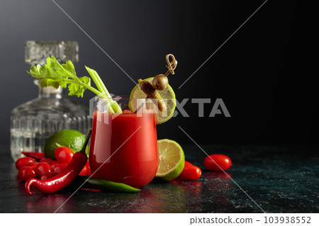 Bloody Mary cocktail garnished with gherkin, olive, lime, and celery. Bloody Mary cocktail garnished with gherkin, olive, lime, and celery. 103938552