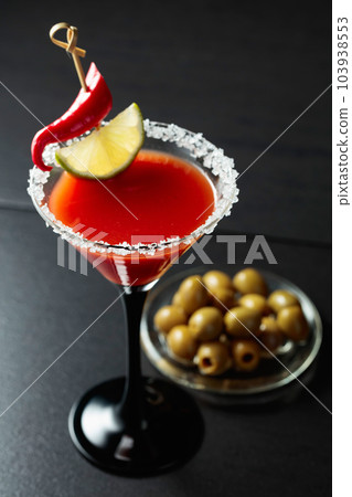 Bloody Mary cocktail with lime, red pepper, and green olives. Bloody Mary cocktail with lime, red pepper, and green olives. 103938553