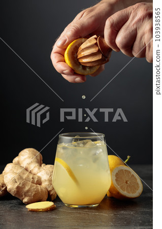 Ginger Ale with ice and lemon on a black background. 103938565