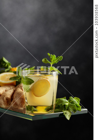 Refreshing summer cocktail with ice, ginger, lemon, and mint. 103938568