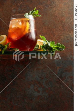 Cocktail with lemon and mint on a background of rustic wall. 103938572