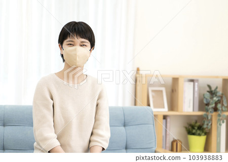 Young woman wearing a mask 103938883