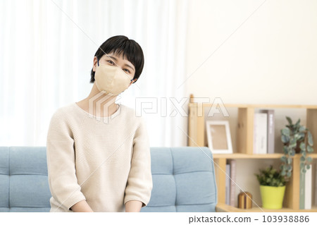 Young woman wearing a mask 103938886