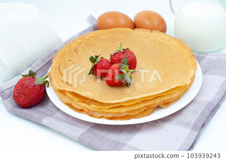 Pancakes with strawberries and ingredients for cooking Pancakes with strawberries and ingredients for cooking 103939243
