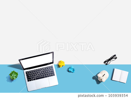 Laptop computer with a piggy bank and office objects Laptop computer with a piggy bank and office objects 103939354