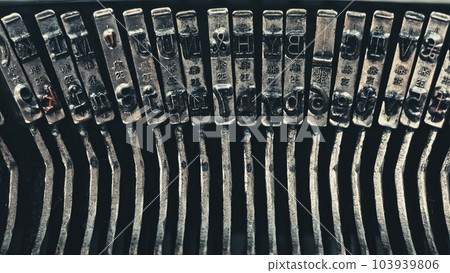 Letters and numbers on typo keys of an old manual typewriter on a retro writing machine, close up view Letters and numbers on typo keys of an old manual typewriter on a retro writing machine, close up view 103939806