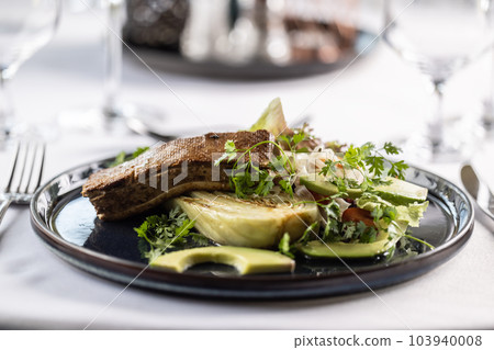 Salad with artichoke and avocade with marinated tofu on top of it 103940008