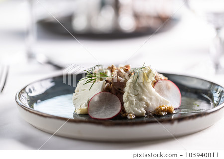 Tender cooked pork with mustard seeds, dressing, cauliflower and mustard seeds on a nice presented plate Tender cooked pork with mustard seeds, dressing, cauliflower and mustard seeds on a nice presented plate 103940011