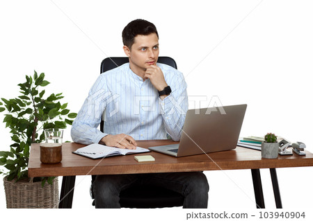 young man using laptop computer for online work at table young man using laptop computer for online work at table 103940904