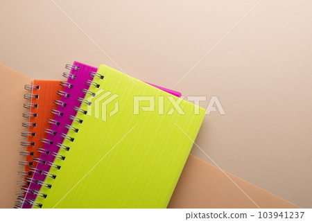 Flat lay of three notebooks with binding with copy space on orange background 103941237