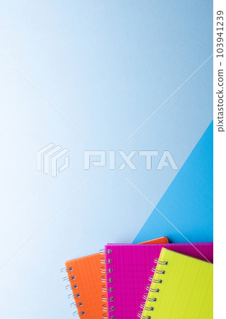 Three notebooks with binding and copy space on blue background Three notebooks with binding and copy space on blue background 103941239