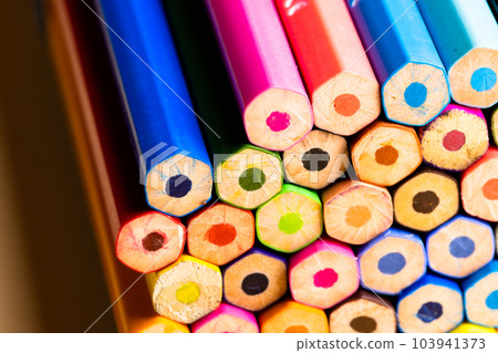 Close up of multi coloured pencils and copy space on orange background 103941373